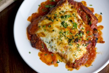 Air fryer chicken parmigiana Traditional Italian comfort dish. Chicken breast covered in breadcrumbs lightly fried, topped with homemade marinara, melted mozzarella, parmigiana provolone and Italian parsley.