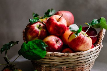 Freshly picked red apples in a wicker basket