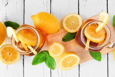 Summer iced tea above view table scene on a white wood background