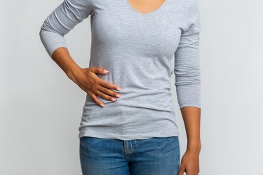 African woman suffering from liver pain, cropped