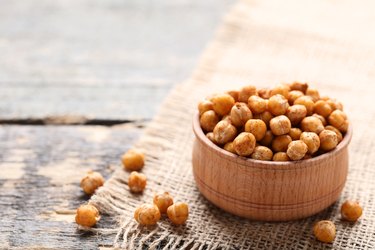 Phosphorous-rich Roasted chickpeas in bowl on gray wooden table