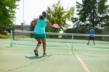 two people playing pickleball outside wearing some of the best pickleball shoe picks.