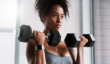 closeup of a strong woman doing Zottman curls for strong biceps