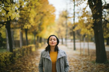 A woman practicing color breathing during a walk in the park