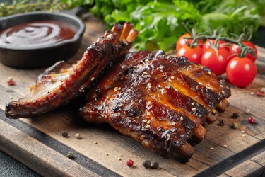 Closeup of beef spare ribs grilled with BBQ sauce and caramelized in honey on a wooden Board