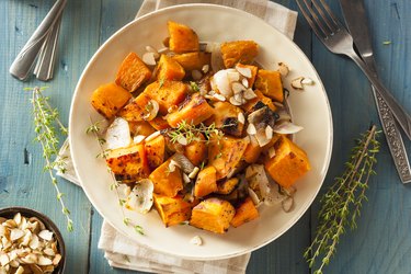 Bowl of cooked sweet potato cubed and seasoned with herbs and spices