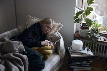 Teenage girl sleeping on sofa during the daytime