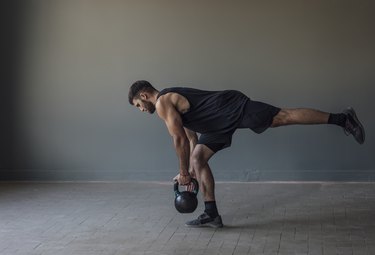 person doing a single-leg deadlift with a kettlebell