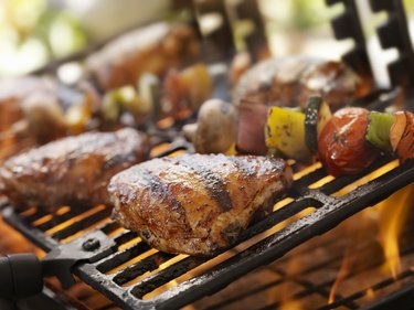 Grilling chicken on a Weber gas grill with vegetables