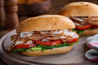 Turkey Submarine Sandwich on a wooden platter, as an example of foods to avoid with fibroids