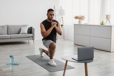 Person doing a lunge exercise in living room