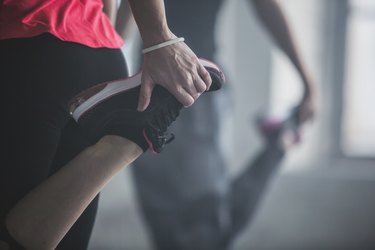 closeup of people doing the shrimp squat exercise