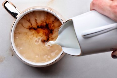 high angle view of a mug of tea with milk, as an example of a liquid to avoid before a colonoscopy