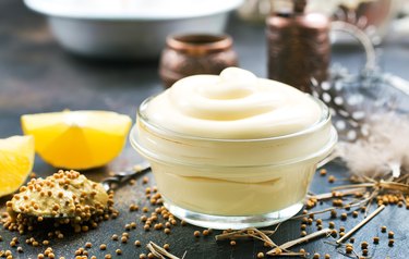 small bowl of mayonnaise with lemon slices and seasonings