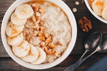healthy breakfast bowl. oatmeal with banana, walnuts, chia seeds and honey