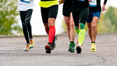 cropped view of runners with wide calves wearing compression socks