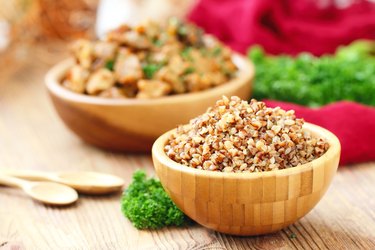 Buckwheat in a wooden bowl and fresh vegetables