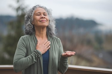 Hawaiian woman doing breathing exercises for COPD outside