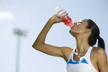 Young female athlete drinking Gatorade for constipation