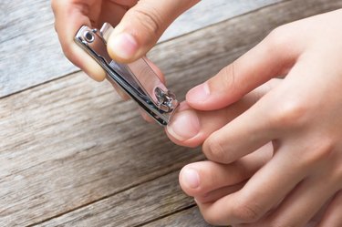 person trimming their toenails to avoid ingrown nails