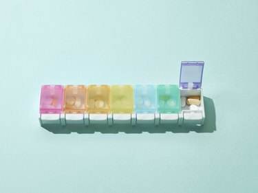 Seven-day pill box on blue background