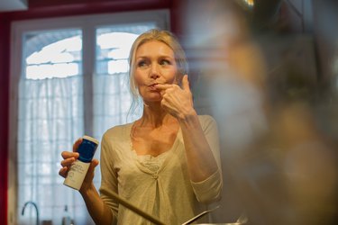 A woman tasting food while cooking to check for too much salt