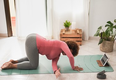 person doing thread the needle yoga pose on green mat experiencing yoga farts