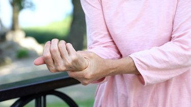 older woman massaging the tendonitis in her wrist