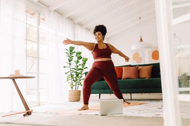 Person doing yoga at home in their living room.