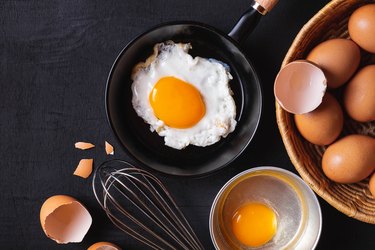 Directly above shot of eggs, a major food allergen, and egg on table