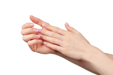 Well-groomed female hands with manicure on white background