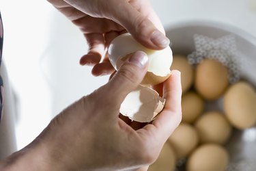 Woman Peeling Shell from Boiled Egg, as a stye remedy