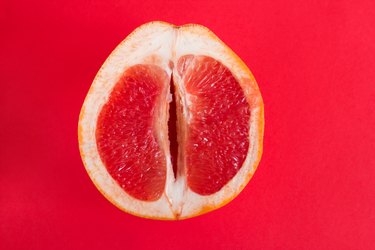 half of fresh ripe grapefruit that looks like a vagina to represent sweet-smelling vaginal odor