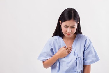 sick stressed woman with acid reflux, gerd symptoms