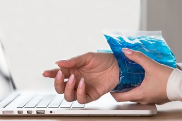 Cropped Hands Of Woman Holding Ice Bag On Wrist, as an over-the-counter tendonitis treatment