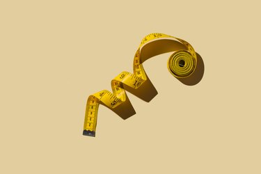 Measuring tapes on beige background