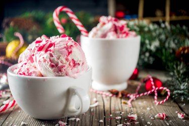 Peppermint Candy Cane Ice Cream in white cup on table with garland