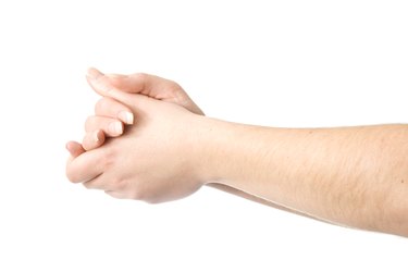 close up of person rubbing hands together on white background