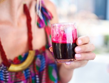 Woman holding glass of a beetroot juice for weight loss