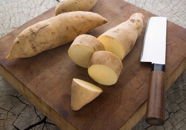 Hannah sweet potatoes on a wooden cutting board