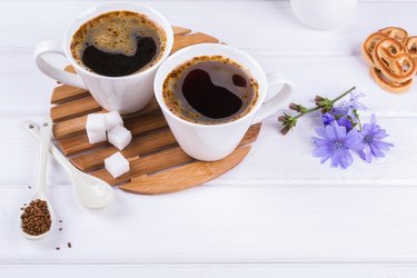 Cup of coffee tea chicory drink hot beverage  with chicory flower and sugar cookies. Still life with breakfast