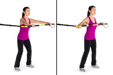 Woman performing rip lunge press TRX exercise