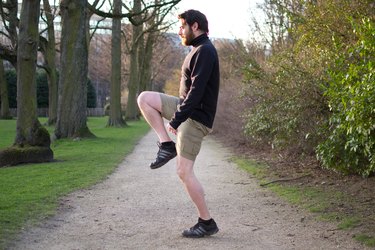 Man performing high knees before a bike ride