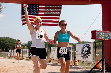 Young women running a race hand in hand