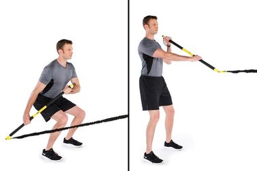 Man performing rip paddleboard row TRX exercise