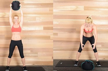 Woman performing medicine ball slam exercise ab exercise.