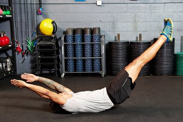 Man doing hollow body rock ab exercise