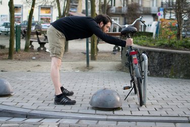 Man performing chest stretch before a bike ride