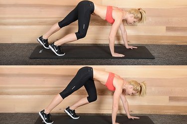 Woman performing bear crawl exercise ab exercise.