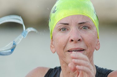 Triathlete poses for photo during race